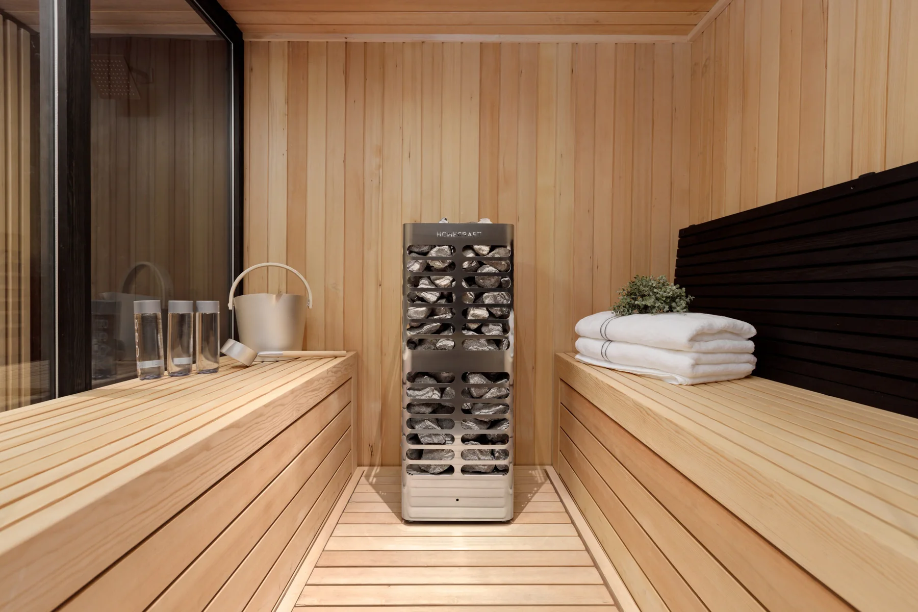 HomeCraft sauna heater beside cedar benches