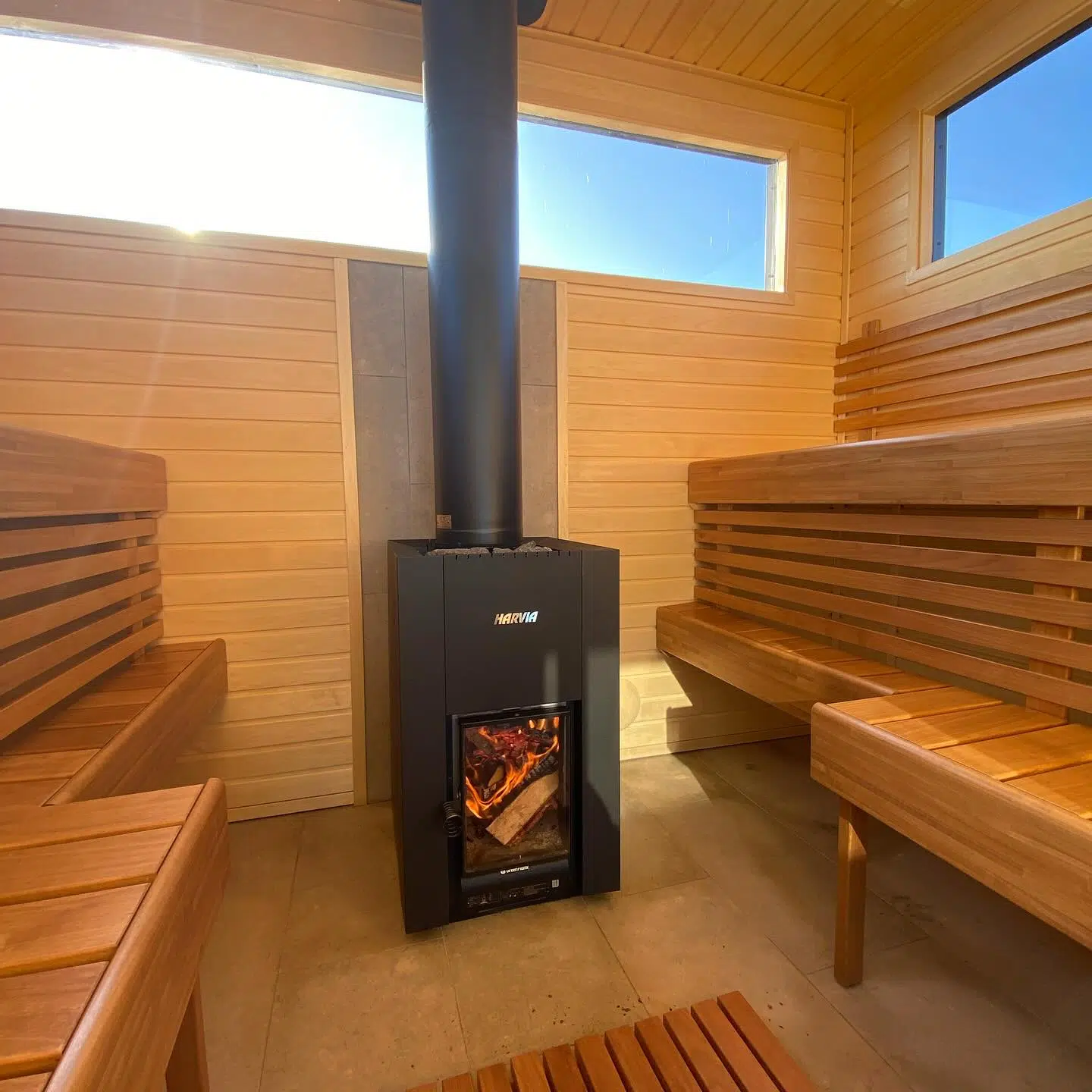 Wood-burning sauna heater with a visible flame