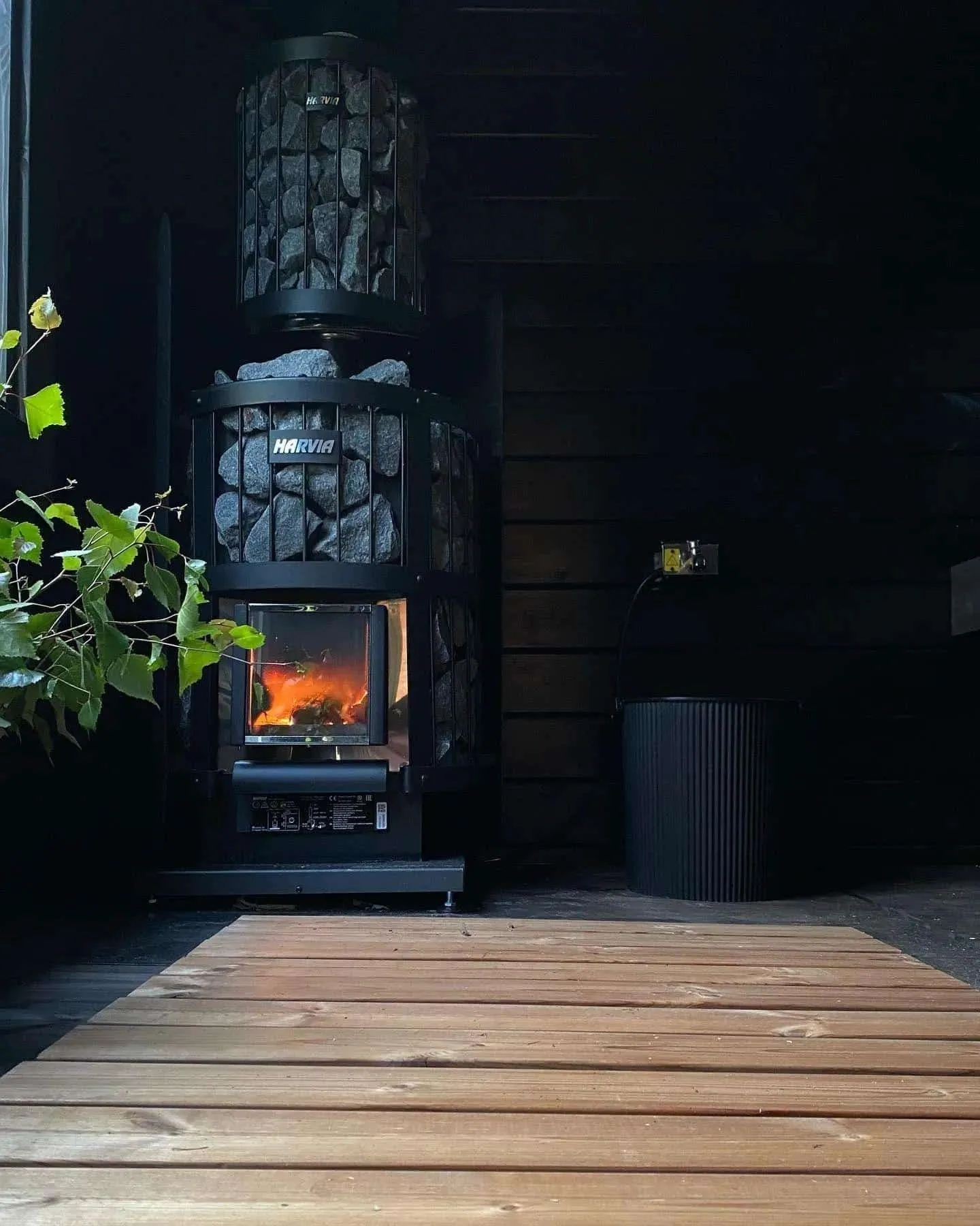 Wood-burning sauna stove with a visible fire