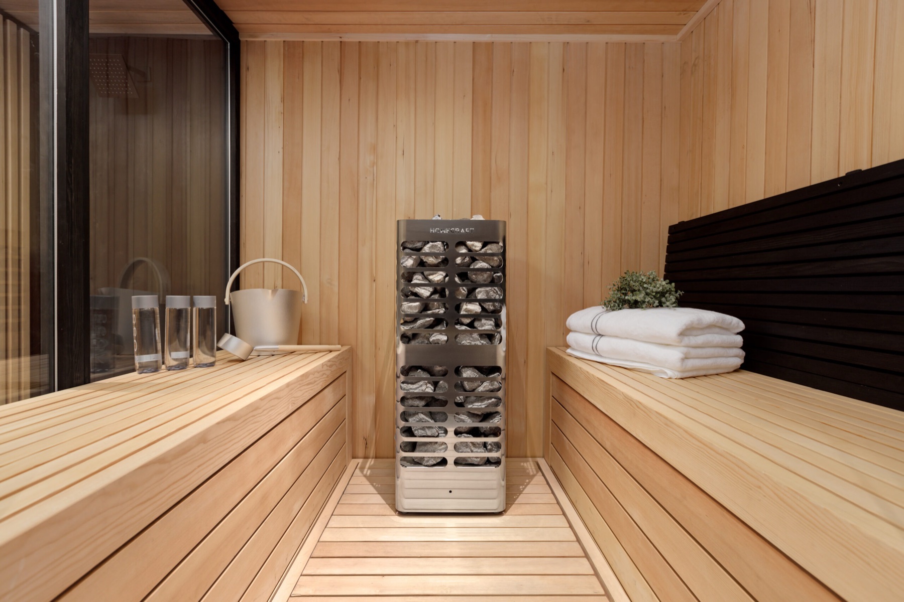 Homecraft electric sauna heater installed in a warm wood sauna