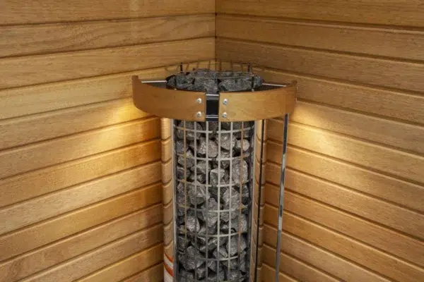 Harvia Cilindro electric sauna heater, installed in a sauna corner with safety railing