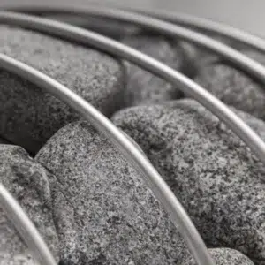 HUUM sauna stones, close-up of stones and curved cage bars