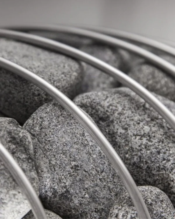 HUUM sauna stones, close-up of stones and curved cage bars