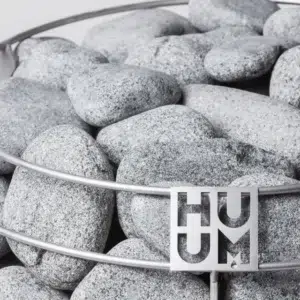 HUUM sauna stones, close-up of stones and the HUUM logo