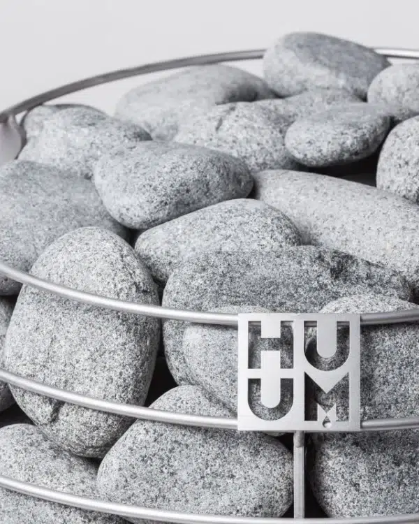 HUUM sauna stones, close-up of stones and the HUUM logo