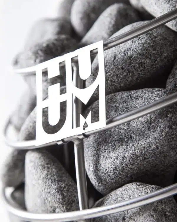 HUUM sauna stones, HUUM logo in front of stacked sauna stones