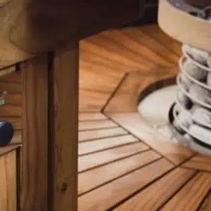 HUUM UKU sauna control, wood control panel installed beside a sauna heater