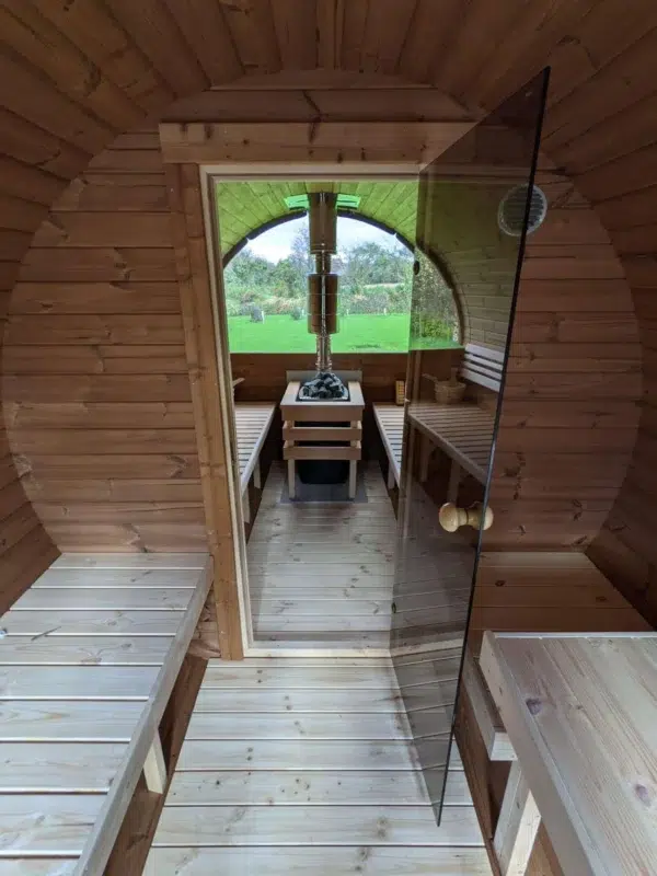 Outdoor barrel sauna, changing area and glass sauna door