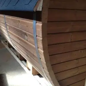 Outdoor barrel sauna, close-up of wooden cladding and metal band