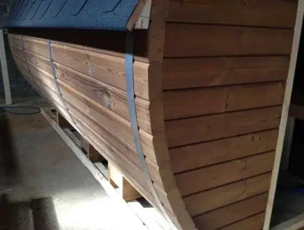 Outdoor barrel sauna, close-up of wooden cladding and metal band