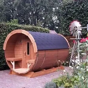 Outdoor barrel sauna, exterior with front porch in a garden