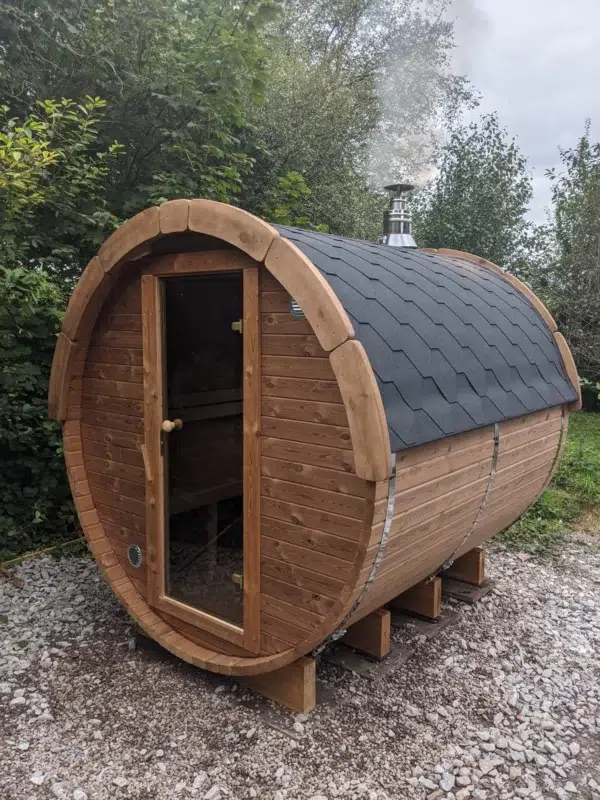 Outdoor barrel sauna, exterior with glass entrance door