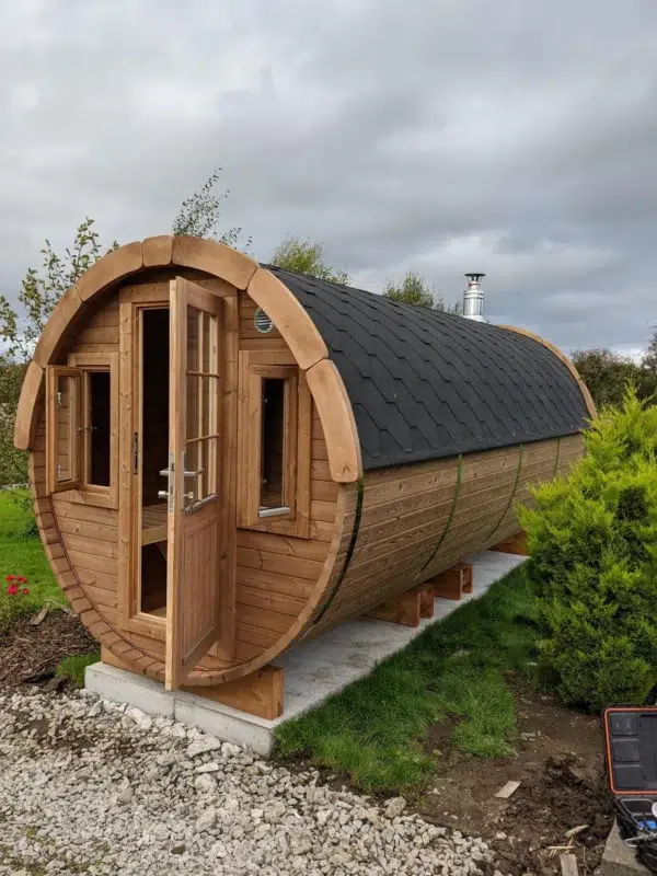 Outdoor barrel sauna, exterior with glazed entrance door and windows
