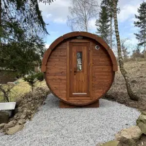 Outdoor barrel sauna, front entrance on a gravel pad