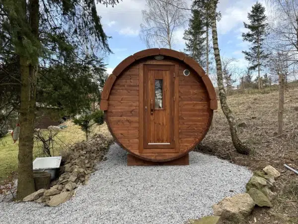 Outdoor barrel sauna, front entrance on a gravel pad