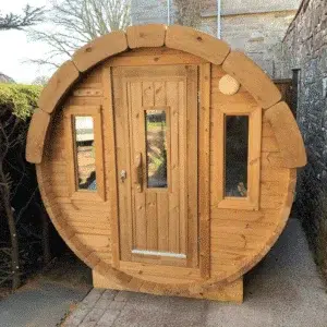 Outdoor barrel sauna, front exterior with a wooden entrance door