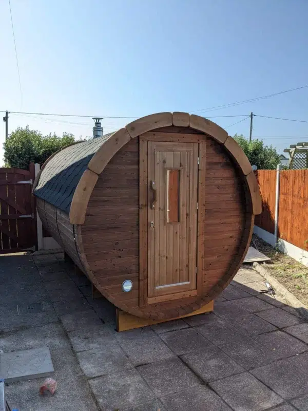 Outdoor barrel sauna, front exterior with wooden entrance door