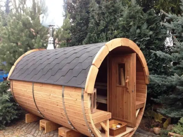 Outdoor barrel sauna, front porch and side exterior among trees