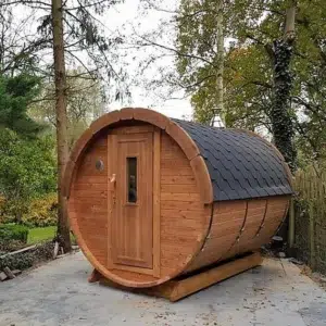 Outdoor barrel sauna, front and side exterior beside trees