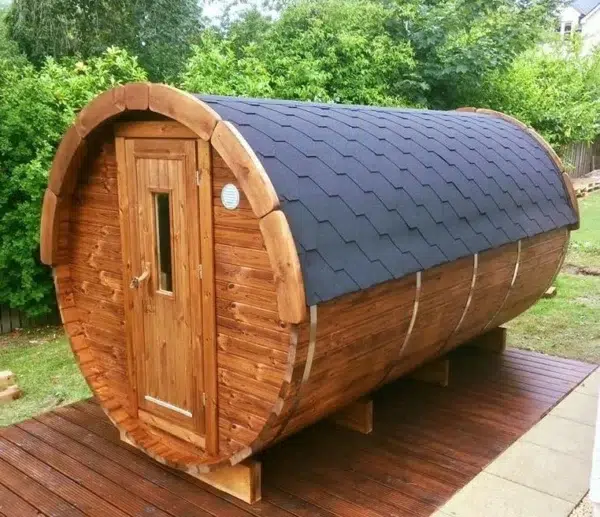 Outdoor barrel sauna, front and side exterior on decking