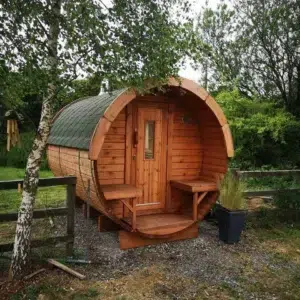 Outdoor barrel sauna, garden installation with front porch