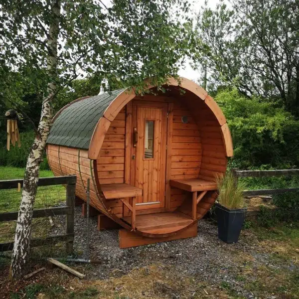 Outdoor barrel sauna, garden installation with front porch