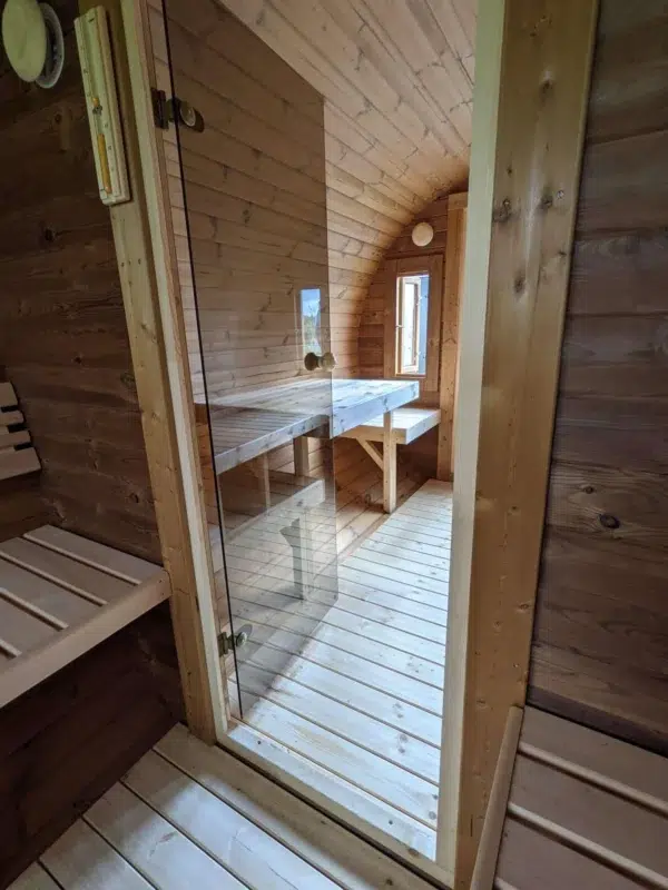Outdoor barrel sauna, glass door and changing-room seating