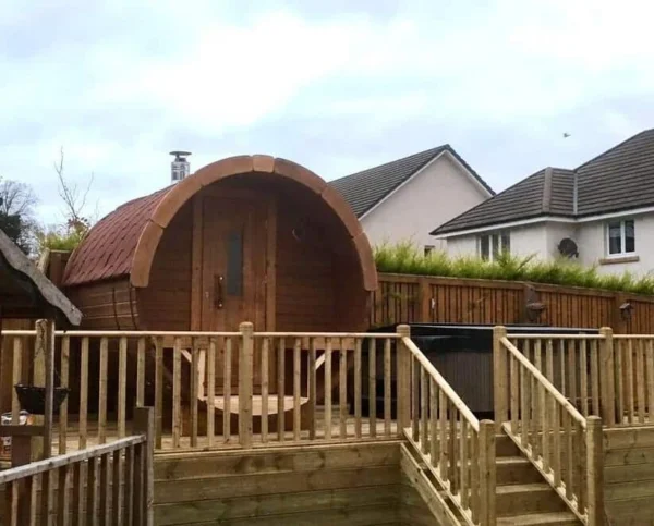 Outdoor barrel sauna, installation on a raised wooden deck