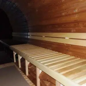 Outdoor barrel sauna, interior bench beside panoramic glazing