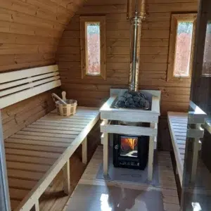 Outdoor barrel sauna, interior benches around a wood-burning stove