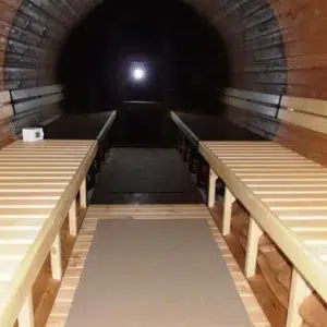 Outdoor barrel sauna, interior with opposing benches and dark panoramic window