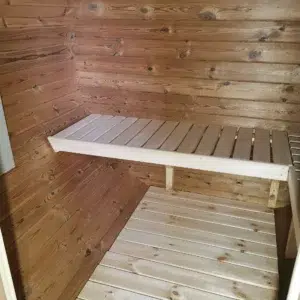 Outdoor barrel sauna, interior wooden bench and floor