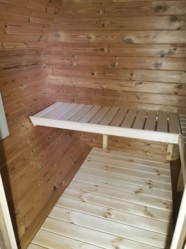 Outdoor barrel sauna, interior wooden bench and floor