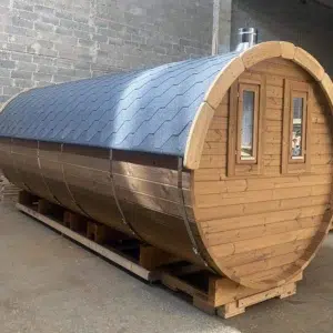 Outdoor barrel sauna, side and rear exterior in a workshop