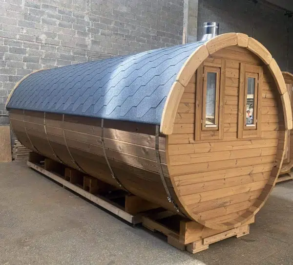 Outdoor barrel sauna, side and rear exterior in a workshop