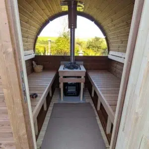 Outdoor barrel sauna, view through doorway to benches and panoramic window