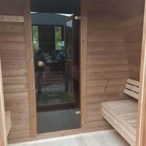 Outdoor pod sauna, changing-room bench and glass sauna door