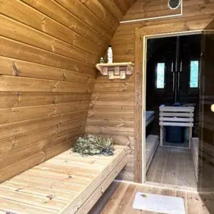 Outdoor pod sauna, changing-room bench and open sauna doorway
