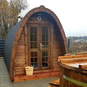 Outdoor pod sauna, front entrance beside an outdoor hot tub