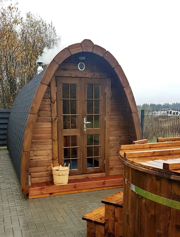 Outdoor pod sauna, front entrance beside an outdoor hot tub