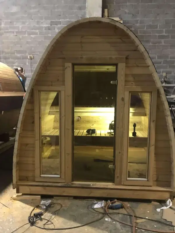 Outdoor pod sauna, front entrance with interior lighting