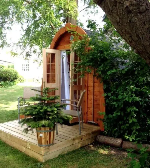 Outdoor pod sauna, front entrance on a wooden deck
