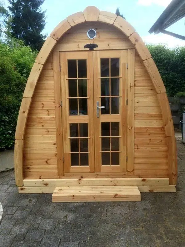 Outdoor pod sauna, front exterior with glazed double doors