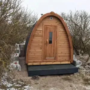 Outdoor pod sauna, front exterior on a raised base