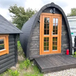 Outdoor pod sauna, front exterior with small entrance deck