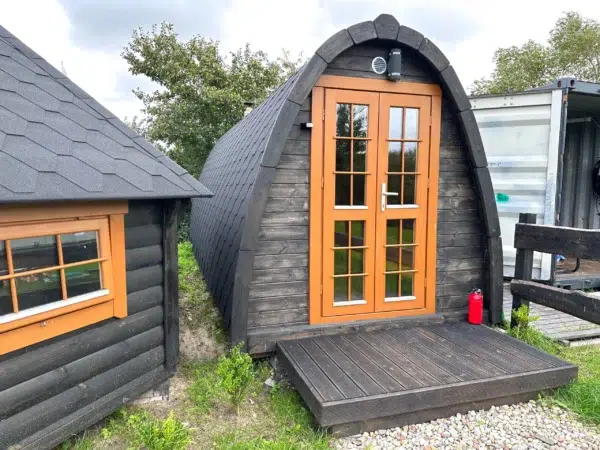 Outdoor pod sauna, front exterior with small entrance deck