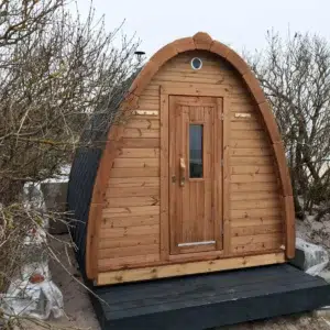 Outdoor pod sauna, front exterior with wooden entrance door