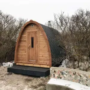 Outdoor pod sauna, front and side exterior on a raised base