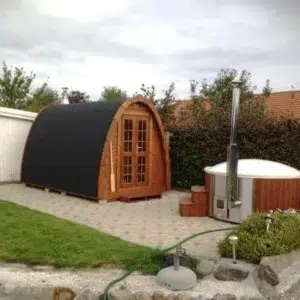 Outdoor pod sauna, garden installation beside an outdoor hot tub