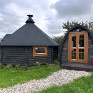 Outdoor pod sauna, garden installation beside a separate hut
